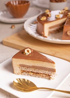 a piece of cake on a plate with a fork next to it and another slice is missing