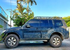 a blue suv parked in front of a house