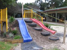 an outdoor play area with slides and playground equipment