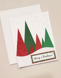 two christmas cards with trees on them sitting next to each other, one is green and the other is red