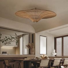 a dining room table and chairs in front of a mirror