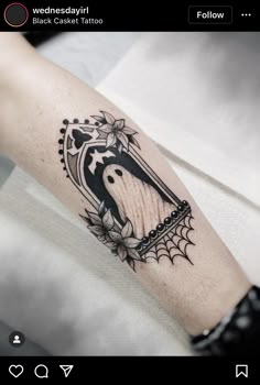 a black and white photo of a person's arm with a tattoo on it