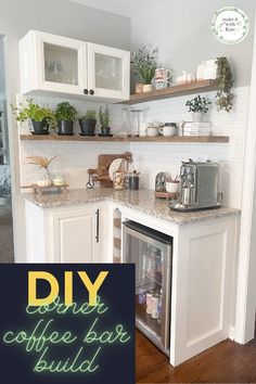 a small kitchen with white cabinets and green lettering on the wall that says diy coffee bar build