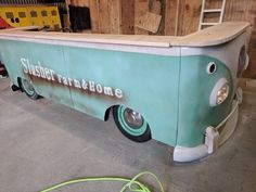 an ice cream truck is parked in a garage next to some wood planks and other tools