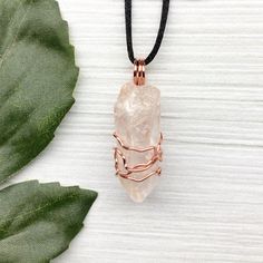 Natural Clear Quartz Necklace. Raw Clear Quartz crystal wrapped with 99.9% pure copper wire that is tarnish resistant. Comes on a black satin lobster clasp necklace. You get the exact pendant pictured.  Pictures are taken close up. Exact pendant measurement is 1.8 Inches H X 0.6 Inches W. This Clear Quartz is from Brazil. ✨ Pendant handcrafted during the Moon in Pisces. ✨ Items included with purchase- -Raw Clear Quartz copper pendant on a black lobster clasp necklace. -Drawstring pouch. -Handmad Rose Gold Copper Wire Necklace For Gift, Rose Gold Copper Wire Necklace Gift, Adjustable Hand Wrapped Copper Crystal Necklaces, Adjustable Hand Wrapped Copper Crystal Necklace, Rose Gold Hand Wrapped Necklace Gift, Electroformed Crystal Necklace With Copper Wire, Spiritual Adjustable Copper Crystal Necklaces, Adjustable Spiritual Copper Crystal Necklaces, Handmade Adjustable Rose Gold Crystal Necklaces