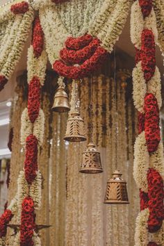 the bells are adorned with red and white flower leins for an elegant wedding ceremony