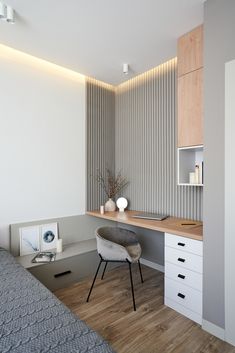 a bed room with a neatly made bed next to a desk and drawers on the wall