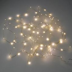 a bunch of lights that are laying on the ground in front of a white wall