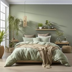 a bed with green sheets and pillows in a room next to potted plants on the wall