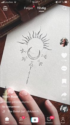 someone is drawing on paper with their hand