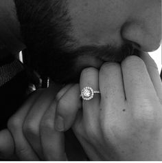 a man holding his hand to his face with a diamond ring on it's finger