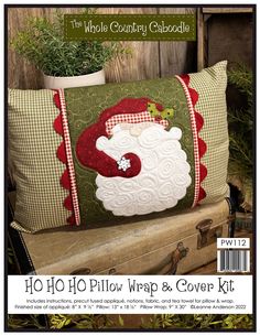 a pillow that is sitting on top of a piece of wood and has a santa clause design