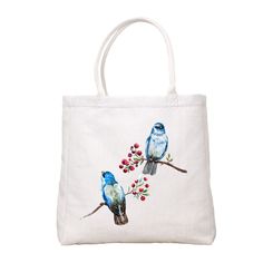 a white bag with two blue birds on it and berries in the back, sitting on a branch