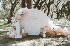 a pink barn with balloons and decorations