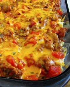 a casserole dish with meat, cheese and tomatoes