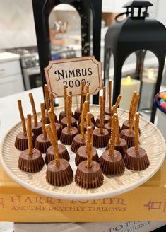 there are many chocolates on the plate with sticks sticking out of them and a sign that says nimbus 2009