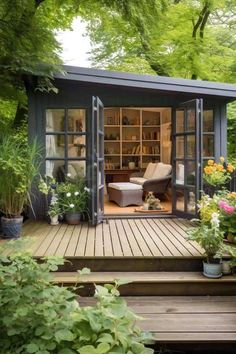 a small garden shed in the middle of a wooden decked area with potted plants