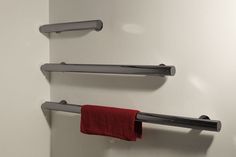 two towel racks are hanging on the wall