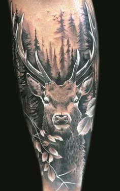 a man's leg with a deer and trees on it