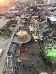 an aerial view of a carnival with rides and people