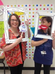 two women are holding up pictures in front of their faces and one has a fake tooth