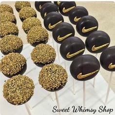 chocolate covered cake pops with golden sprinkles on top are lined up in rows