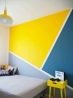 a bedroom with yellow, blue and white walls