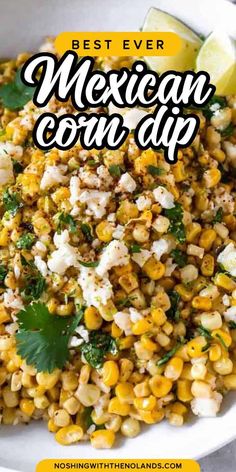 mexican corn salad in a white bowl with cilantro and lime on the side