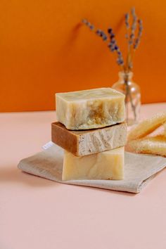 three pieces of soap sitting on top of a napkin next to some french fries and a vase with flowers