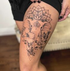 an elephant with flowers on it's thigh is seen in this tattoo photo taken by a woman