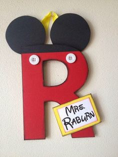 the letter r is decorated with mickey mouse ears and has a name tag attached to it