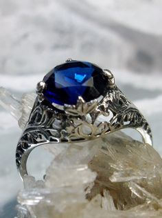 blue sapphire solitaire ring with swirl antique floral sterling silver filigree Sapphire Ring In Sterling Silver With Intricate Design, Silver Filigree Sapphire Ring, Silver Sapphire Filigree Ring, Silver Sapphire Ring With Filigree, Filigree Sapphire Ring Gift, Gift Sapphire Ring With Filigree, Wedding Filigree Sapphire Ring, Sapphire Filigree Ring In Sterling Silver, Blue Sapphire Ring With Intricate Design