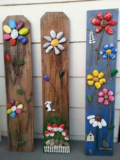 three wooden boards with flowers painted on them