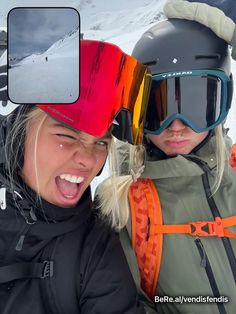 two women with ski goggles and snowboards on their heads