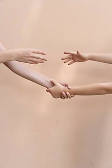 two hands reaching out towards each other