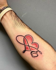 a man's arm with a tattoo on it that has a heart in the middle