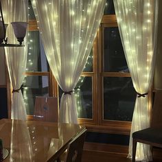 a dining room with lights on the windows