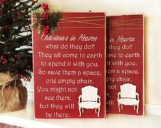 two wooden christmas signs sitting on top of a mantle next to a small christmas tree