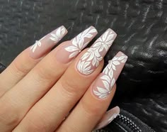 a woman's hand with white flowers on it