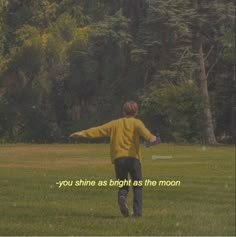 a person in a field with a frisbee that says, you shine as bright as the moon