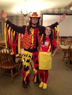 a man and woman dressed in costume standing next to each other