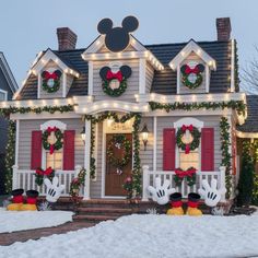 a house decorated for christmas with mickey mouse decorations