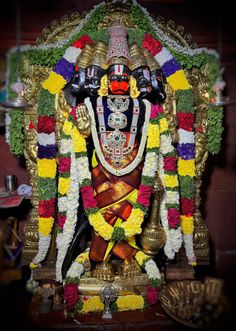 the statue is decorated with flowers and other decorations