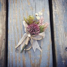 a bouquet of flowers tied to a piece of wood