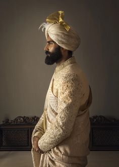 a man with a turban standing in front of a bench