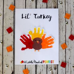 a handprint turkey on a piece of paper with orange and red blocks around it