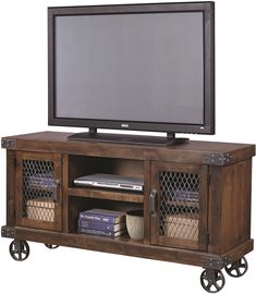 a flat screen tv sitting on top of a wooden entertainment center