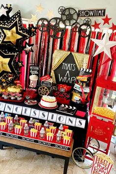 a table topped with lots of red and gold items next to a sign that says, that's a wrap