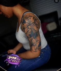 a woman with a tattoo on her arm is sitting next to a skateboard and holding a toothbrush