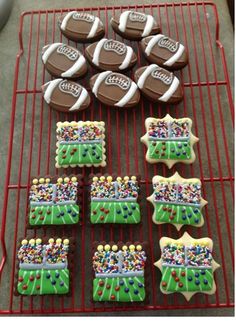 decorated cookies on a cooling rack with footballs and balls in the background for sports themed desserts